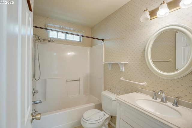 bathroom with vanity, shower / bathing tub combination, toilet, and wallpapered walls