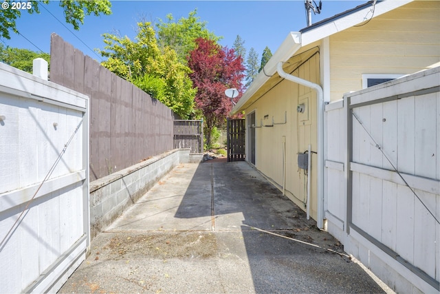 view of side of home featuring a gate and fence