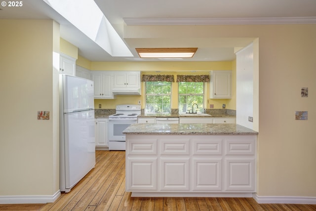 kitchen with a sink, light wood-style floors, white appliances, white cabinetry, and under cabinet range hood