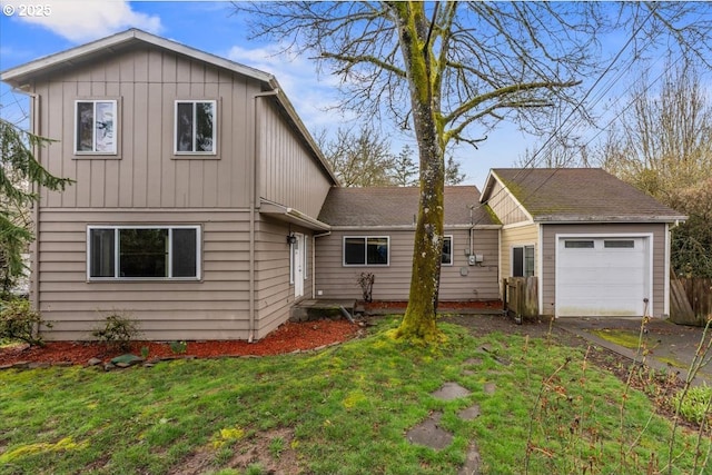 back of house featuring board and batten siding and a yard