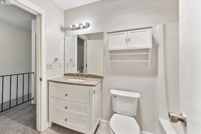 bathroom featuring vanity, tile patterned floors, toilet, and baseboards