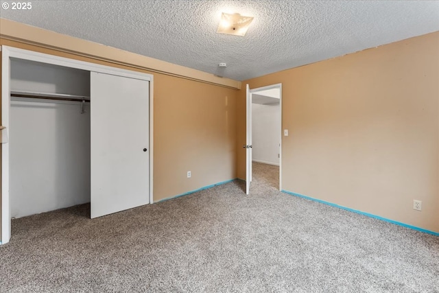 unfurnished bedroom with a closet, carpet flooring, and a textured ceiling