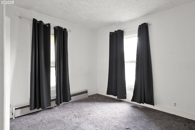 unfurnished room featuring plenty of natural light, a textured ceiling, and carpet
