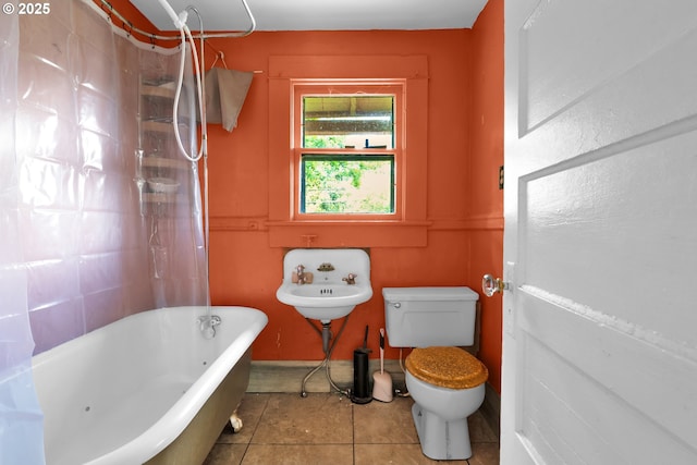 full bathroom featuring toilet, a bath, tile patterned flooring, curtained shower, and a sink