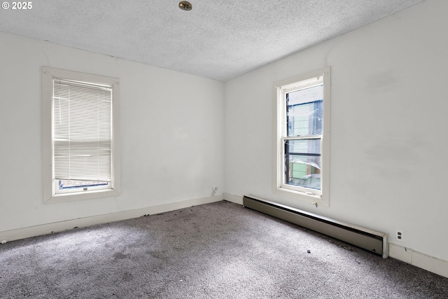spare room featuring baseboard heating, carpet flooring, and a textured ceiling
