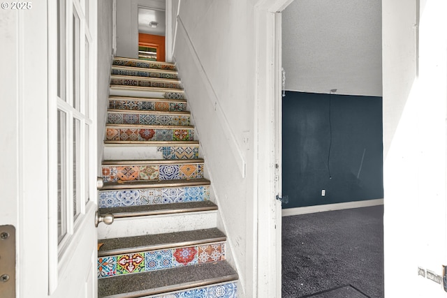 staircase featuring carpet floors