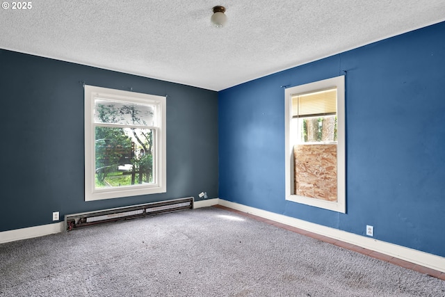 spare room featuring a baseboard radiator, a textured ceiling, baseboards, and carpet floors