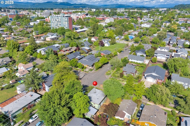 aerial view of property and surrounding area featuring a mountainous background