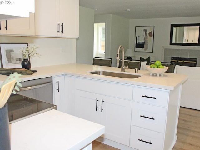 16400 NE 12th St, Vancouver, WA 98684 - kitchen featuring a sink, a peninsula, open floor plan, white cabinets, and light wood-style flooring