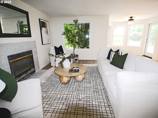 16400 NE 12th St, Vancouver, WA 98684 - living area featuring a tiled fireplace, wood finished floors, and a ceiling fan