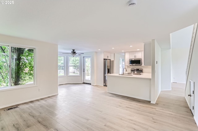 kitchen featuring visible vents, plenty of natural light, white cabinetry, and appliances with stainless steel finishes