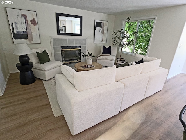 16400 NE 12th St, Vancouver, WA 98684 - living room with a tile fireplace, baseboards, and wood finished floors