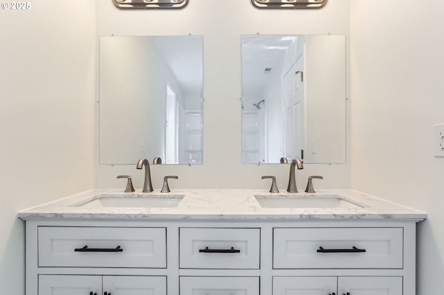 full bathroom featuring double vanity and a sink