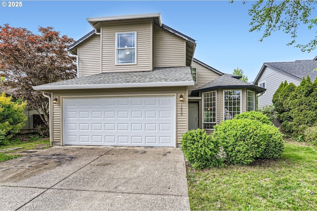 traditional-style home with a garage, roof with shingles, and driveway
