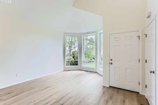 entrance foyer featuring baseboards and light wood-type flooring