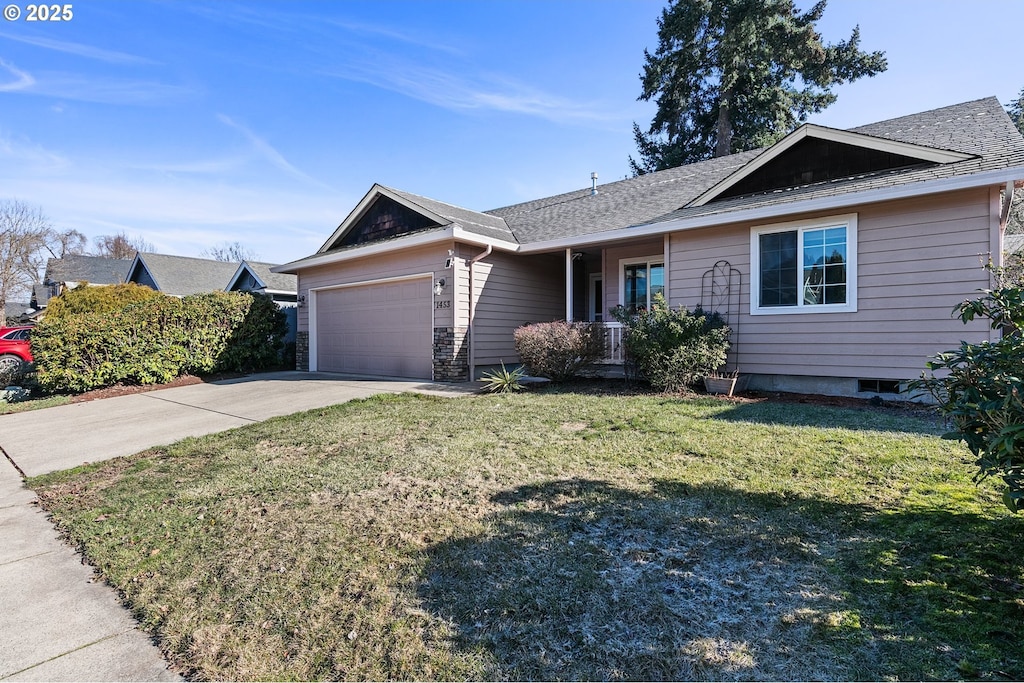 single story home with a garage and a front lawn