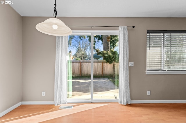 doorway to outside featuring wood-type flooring