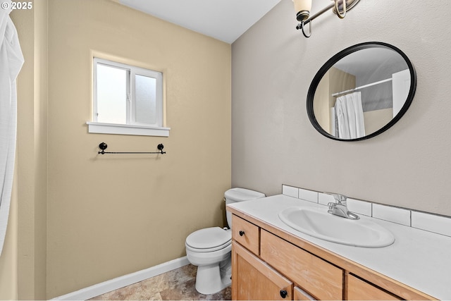 bathroom featuring vanity, curtained shower, and toilet