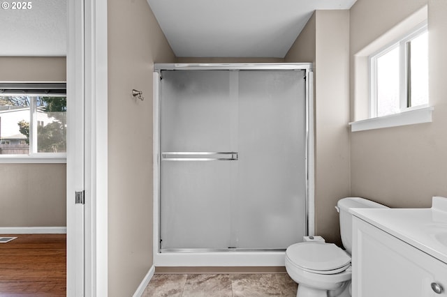 bathroom featuring vanity, toilet, and walk in shower