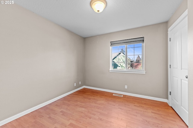 interior space with light hardwood / wood-style floors and a textured ceiling