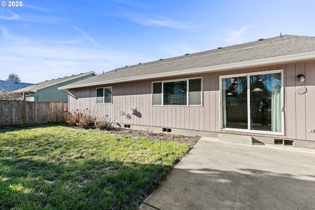 back of property with a yard and a patio area