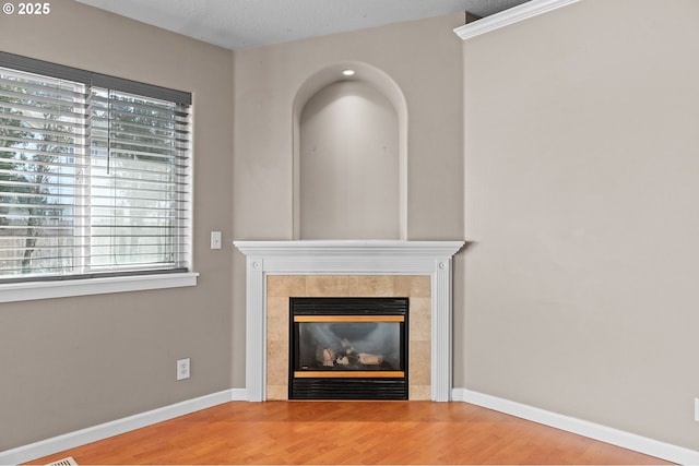 unfurnished living room with a fireplace and hardwood / wood-style floors