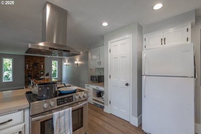 3681 Silverstone Ct NE, Salem, OR 97305 - kitchen with light countertops, stainless steel appliances, extractor fan, and white cabinetry