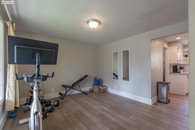 3681 Silverstone Ct NE, Salem, OR 97305 - exercise area with baseboards, a textured ceiling, and wood finished floors
