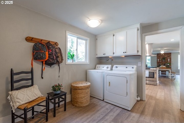 3681 Silverstone Ct NE, Salem, OR 97305 - laundry room featuring cabinet space, a ceiling fan, washing machine and dryer, and light wood-type flooring