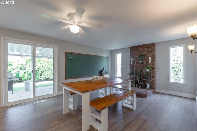 3681 Silverstone Ct NE, Salem, OR 97305 - dining area with visible vents, a brick fireplace, wood finished floors, baseboards, and a ceiling fan