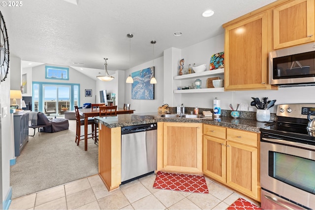 260 N Pacific St, Rockaway Beach, OR 97136 - kitchen with appliances with stainless steel finishes, open floor plan, a sink, a peninsula, and lofted ceiling