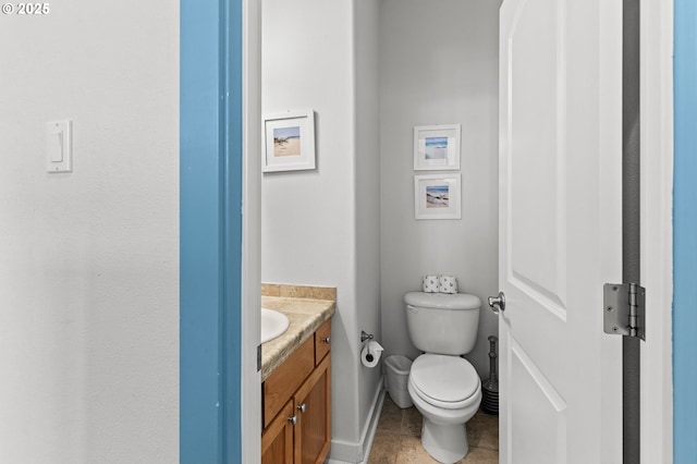 260 N Pacific St, Rockaway Beach, OR 97136 - bathroom with vanity, toilet, baseboards, and tile patterned flooring