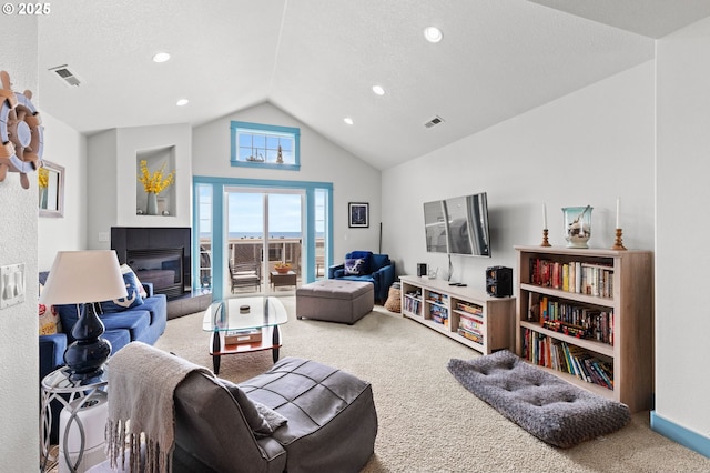 260 N Pacific St, Rockaway Beach, OR 97136 - living room featuring carpet, a tile fireplace, recessed lighting, a textured ceiling, and high vaulted ceiling