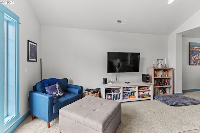 260 N Pacific St, Rockaway Beach, OR 97136 - living room with light colored carpet, lofted ceiling, and baseboards