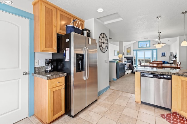 260 N Pacific St, Rockaway Beach, OR 97136 - kitchen with appliances with stainless steel finishes, dark countertops, a textured ceiling, light colored carpet, and open floor plan