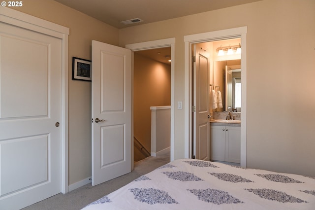 28683 SW Orleans Ave, Wilsonville, OR 97070 - bedroom with a sink, ensuite bathroom, light carpet, and baseboards