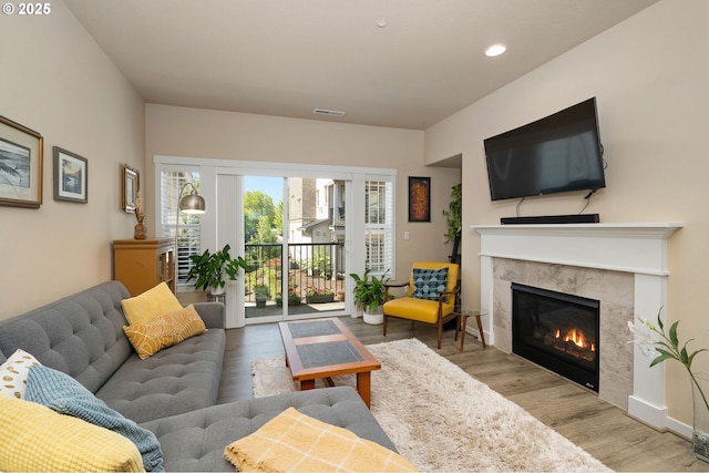 28683 SW Orleans Ave, Wilsonville, OR 97070 - living area featuring wood finished floors, a premium fireplace, recessed lighting, and baseboards