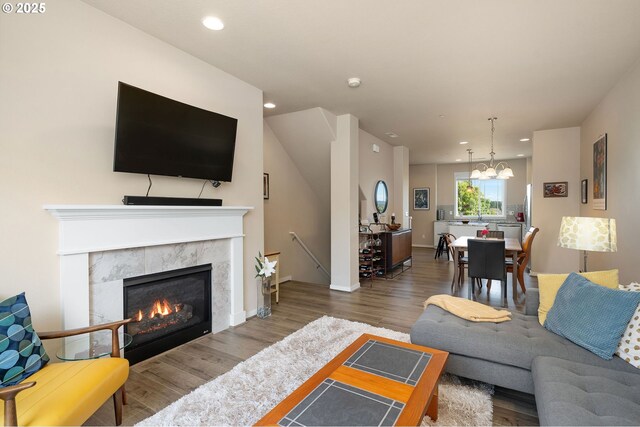 28683 SW Orleans Ave, Wilsonville, OR 97070 - living area with a chandelier, recessed lighting, wood finished floors, a tile fireplace, and baseboards
