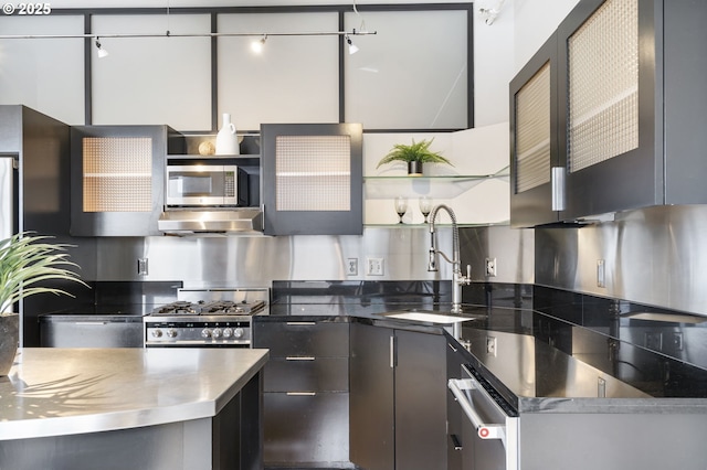 333 NW 9th Ave Unit 713, Portland, OR 97209 - kitchen with stainless steel counters, a sink, open shelves, stainless steel appliances, and tasteful backsplash