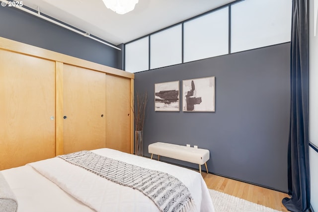 333 NW 9th Ave Unit 713, Portland, OR 97209 - bedroom featuring a closet and wood finished floors