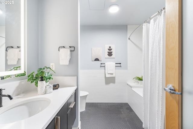 333 NW 9th Ave Unit 713, Portland, OR 97209 - bathroom with vanity, toilet, wainscoting, and tile patterned flooring