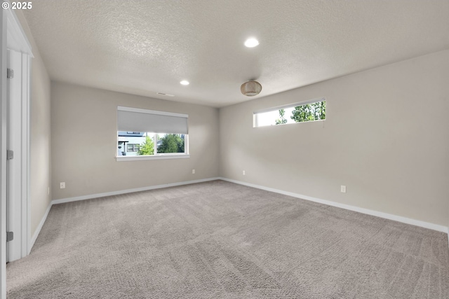 3015 Guadalupe Way, Eugene, OR 97408 - empty room featuring a textured ceiling, carpet, baseboards, and recessed lighting