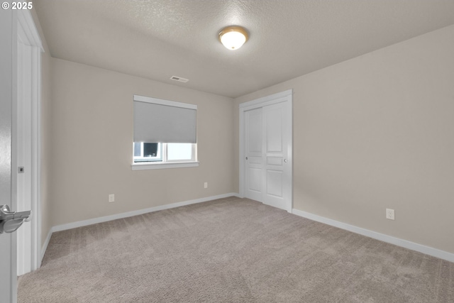 3015 Guadalupe Way, Eugene, OR 97408 - unfurnished bedroom with carpet floors, a textured ceiling, baseboards, and a closet