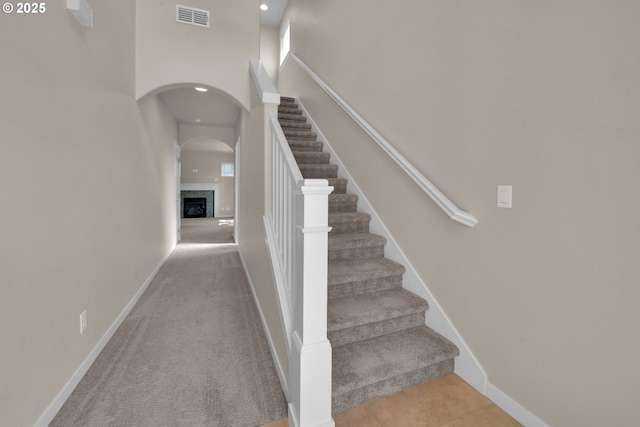 3015 Guadalupe Way, Eugene, OR 97408 - stairway with a fireplace, baseboards, arched walkways, recessed lighting, and carpet flooring