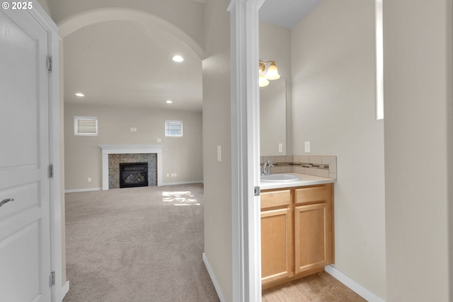 3015 Guadalupe Way, Eugene, OR 97408 - bathroom featuring a fireplace, vanity, recessed lighting, and baseboards