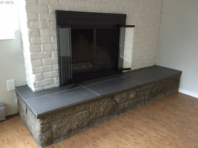 2544 NE Hoyt St, Portland, OR 97232 - interior details with a brick fireplace and wood finished floors