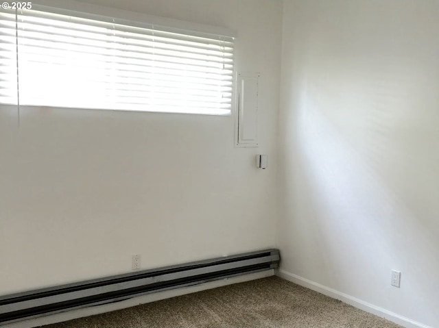 2544 NE Hoyt St, Portland, OR 97232 - empty room featuring carpet flooring, a baseboard heating unit, and baseboards