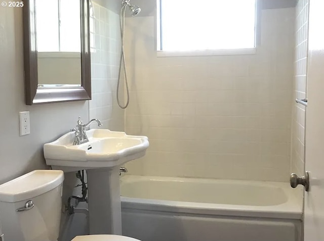 2544 NE Hoyt St, Portland, OR 97232 - bathroom featuring toilet, a healthy amount of sunlight, and washtub / shower combination