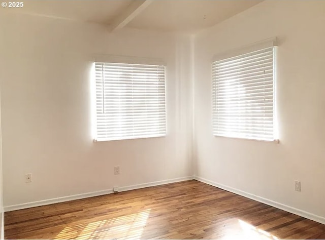 2544 NE Hoyt St, Portland, OR 97232 - spare room with wood finished floors, baseboards, and beam ceiling