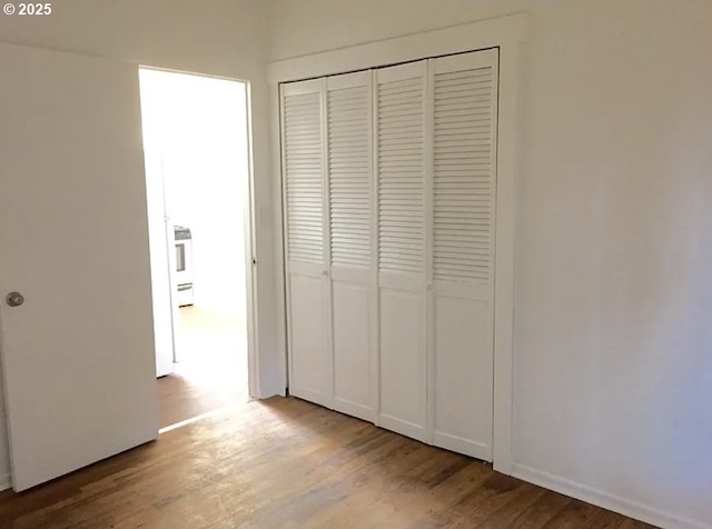 2544 NE Hoyt St, Portland, OR 97232 - unfurnished bedroom with a closet and wood finished floors